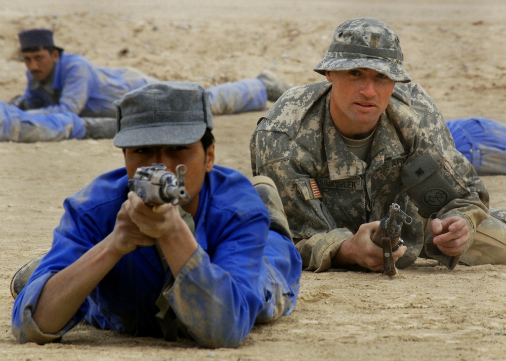 U.S. Army officer and Afghan National Police practice tactical movement as part of the Focused District Development training program at the Kandahar Regional Training Center. (NTM-A photo by David Votroubek)